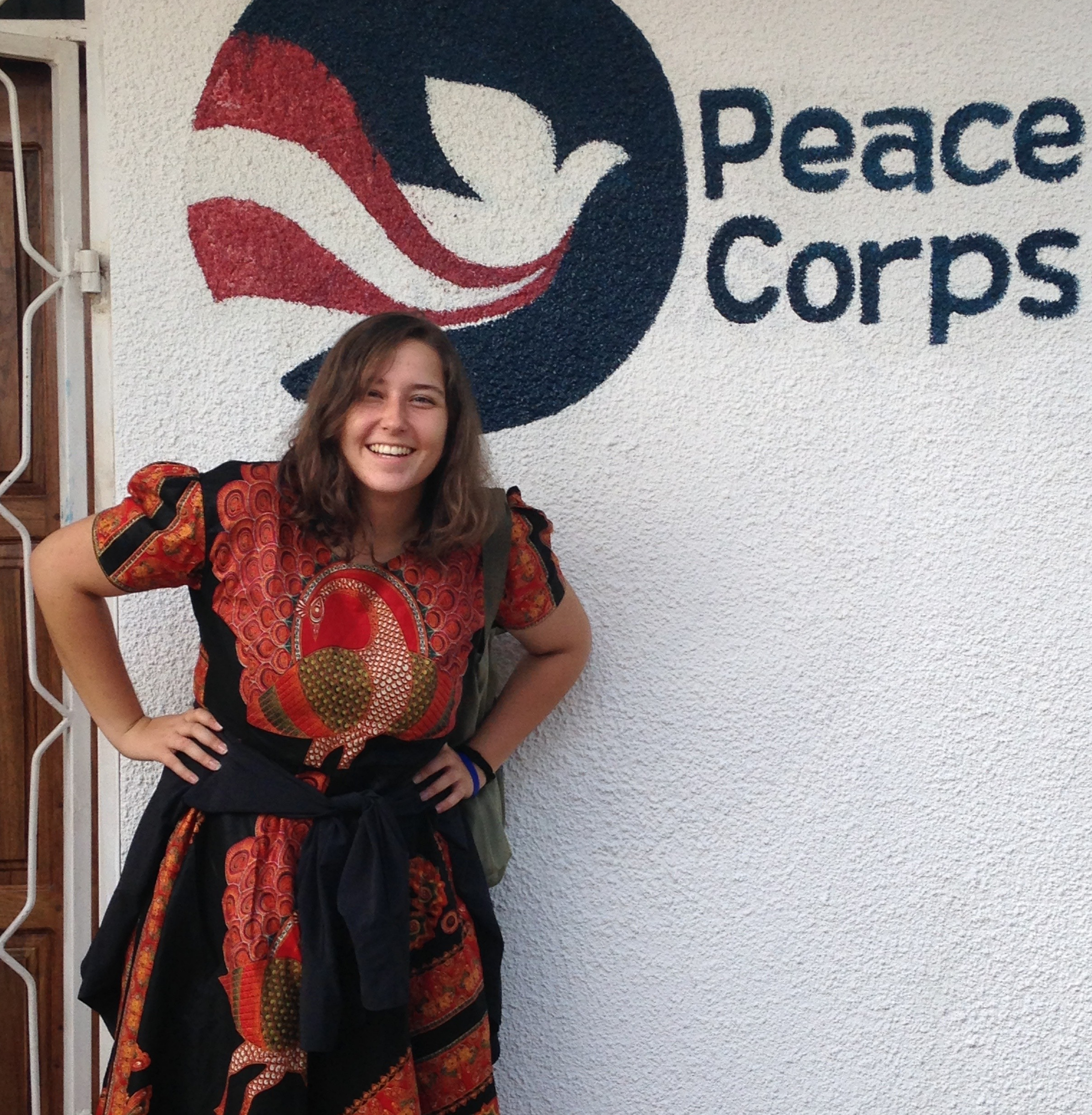 Kenna Dieffenwierth, a Saint Leo University alumna, standing in front of the Peace Corps facility in Tanzania